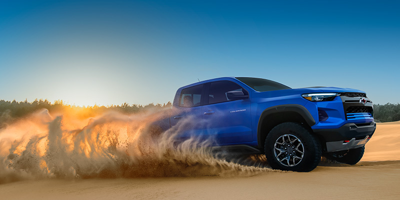 Reef Blue Metallic 2026 Chevrolet Colorado ZR2 parked on a coastal road.