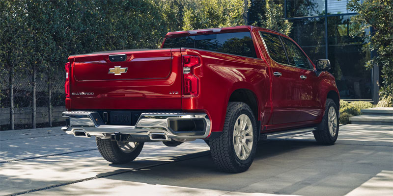 Red Chevrolet Silverado LTZ parked in a driveway.